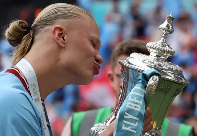 Erling Haaland kisses FA Cup trophy