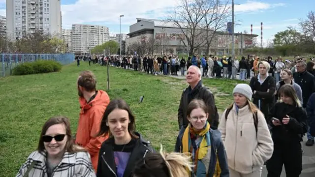 Voters queue outside a polling station set up in a Russian Embassy School in Belgrade on 17 March 2024