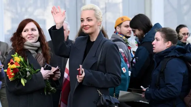 Yulia Navalnaya gestures after she passed the control point