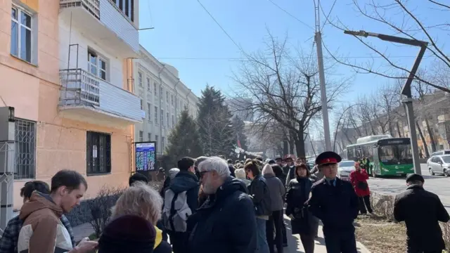 People queue outside a polling station in Bishkek, Kyrgyzstan