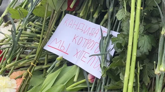 A sign in Russian that says "the candidate we wanted"