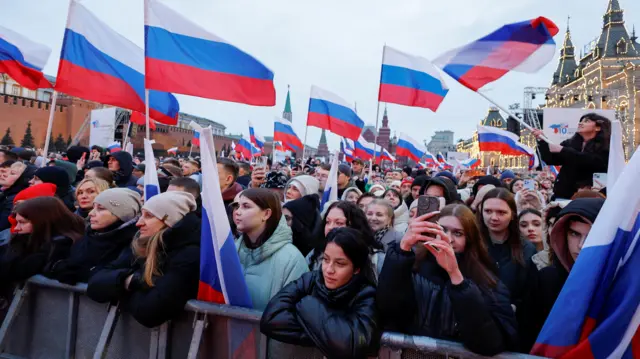 People attend a rally, which marks the 10th anniversary of Russia's annexation of Crimea from Ukraine, in Red Square in central Moscow, Russia