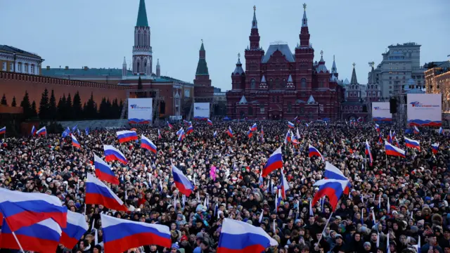 People attend a rally, which marks the 10th anniversary of Russia's annexation of Crimea from Ukraine, in Red Square in central Moscow, Russia