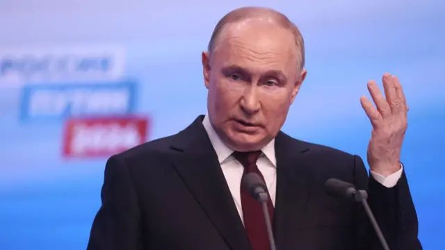 Vladimir Putin gesturing while giving his victory speech