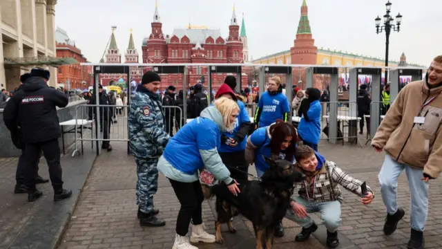 People pose for a selfie in Red Square