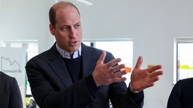 Image of Prince William, who is standing with his arms slightly bent and hands held outright