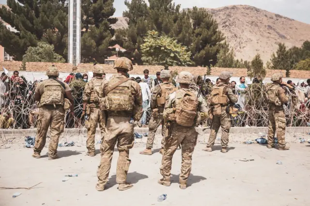 US soldiers and marines assist with security at an evacuation point in Kabul, Afghanistan