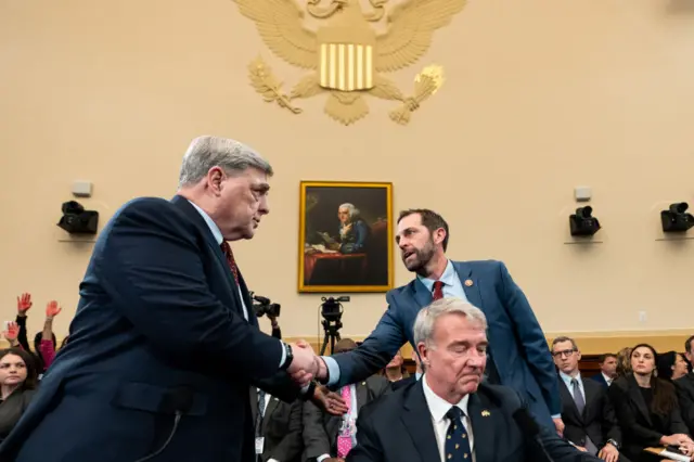 From left, Former Chairman of the Joint Chiefs of Staff Gen. Mark Milley shakes hands with Rep. Jason Crow, D-Colo., before the start of the House Foreign Affairs Committee hearing on "An Assessment of the Biden Administration's Withdrawal from Afghanistan by America's Generals" in the Rayburn House Office Building on Tuesday, March 19, 2024. Former Commander of United States Central Command Gen. Kenneth McKenzie Jr. is seated bottom right.