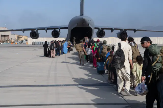 In this handout provided by US Central Command, passengers board aircraft to be evacuated