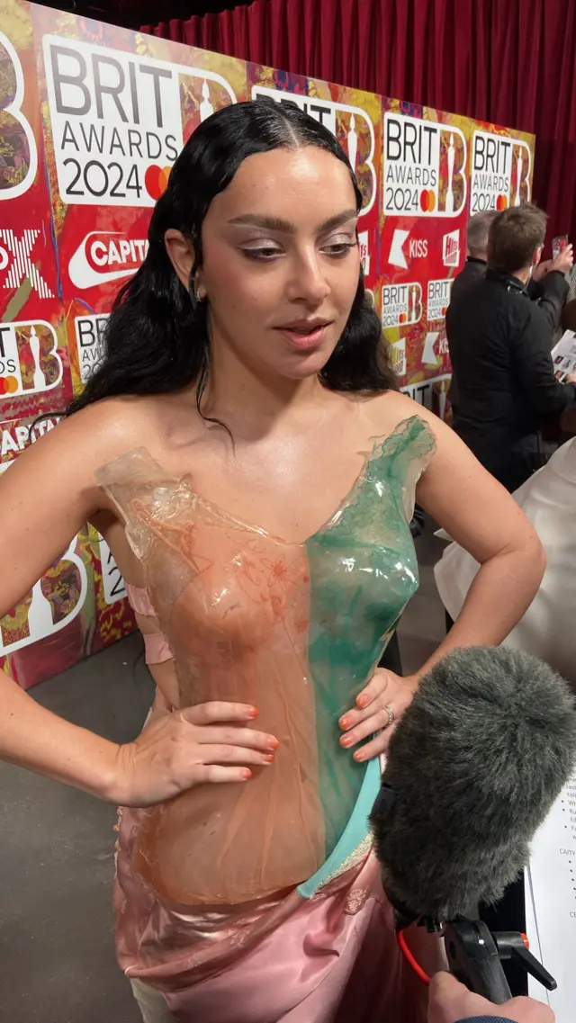 Charli XCX in a resin dress on the red carpet at the Brit Awards