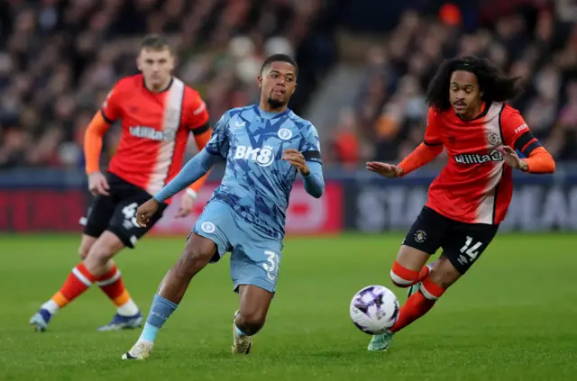 Leon Bailey dribbles away from Tahith Chong in midfield.