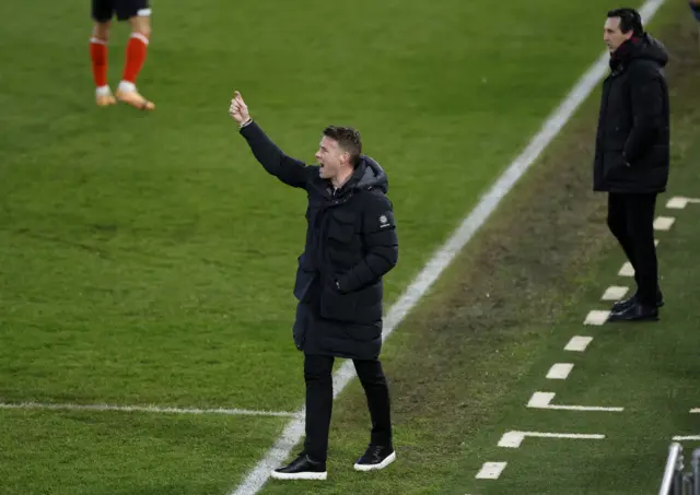 Rob Edwards shouts and points instructions to his players.