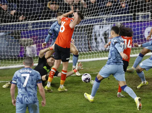 Chong taps home in a penalty box melee.