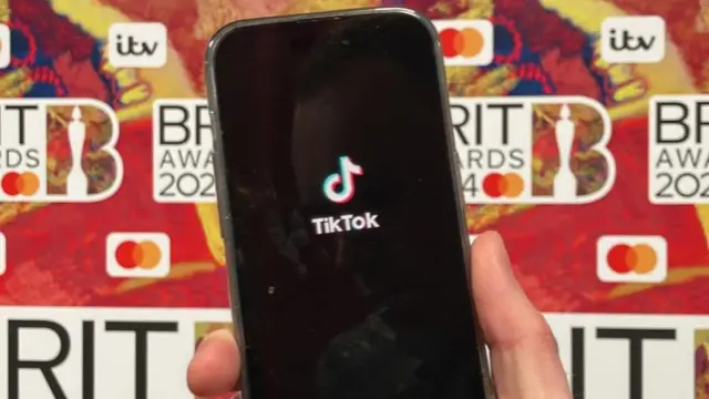 TikTok app opened on a phone on the Brits red carpet