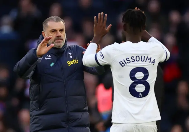 Bissouma and Postecoglou high five at full time.