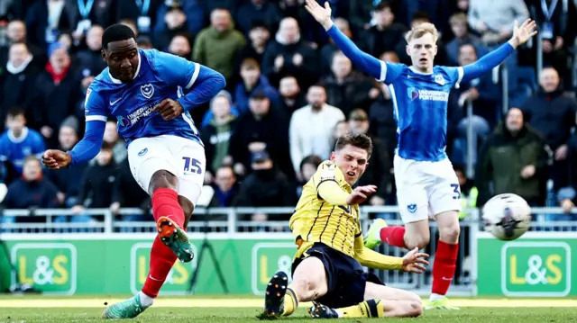 Christian Saydee of Portsmouth scores a goal against Oxford