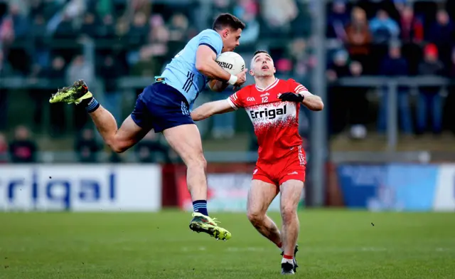 Dublin's Brian Howard takes to the air as Niall Toner looks on