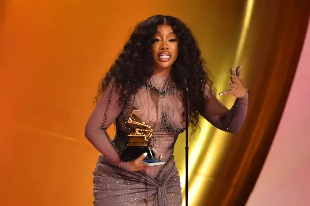 SZA accepts the Best R&B Song award for Snooze on stage during the 66th Annual Grammy Awards in February