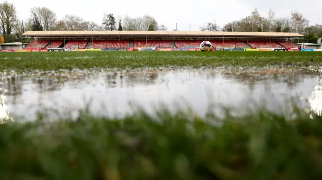 General view of a wet pitch at the Broadfield Stadium, Crawley