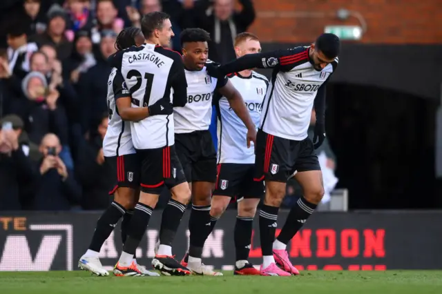 Traore is mobbed by teammates.