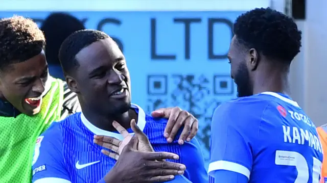 Portsmouth players celebrate Christian Saydee's winner