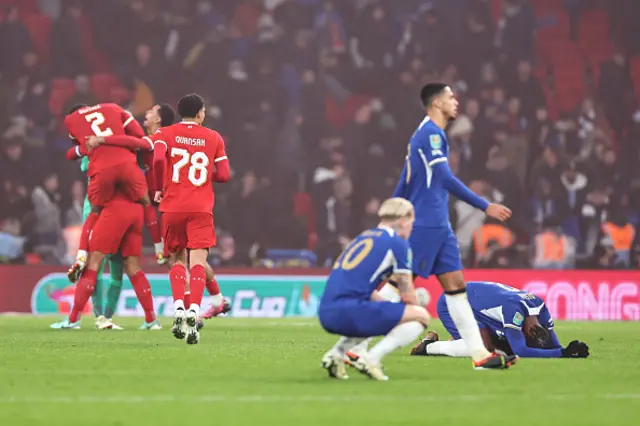 Players of Liverpool celebrate at full time behind dejected players of Chelsea