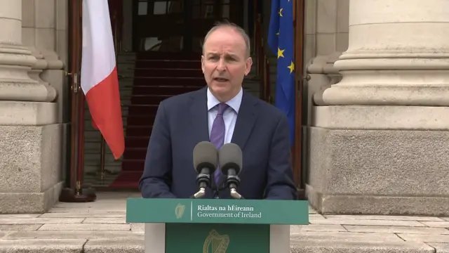 Micheál Martin speaking outside government buildings