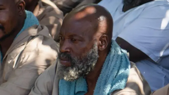 Madzibaba Ishmael Chokurongerwa (2-R) sits outside the Norton Magistrate Court for trial over minors abuse charges in Norton, Zimbabwe, 19 March 2024