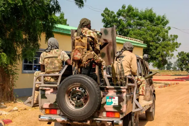 Nigerian Army soldiers are seen driving on a military vehicle in Ngamdu, Nigeria, on November 3, 2020.