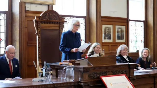 Queen Camilla delivers a speech on behalf of King Charles I