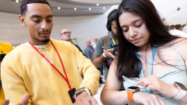 Andrea Angeles, 22, and Ronald Arriola, 23, try on the new Apple watch Ultra at an Apple event at Apple Park in Cupertino, California on September 7, 2022.