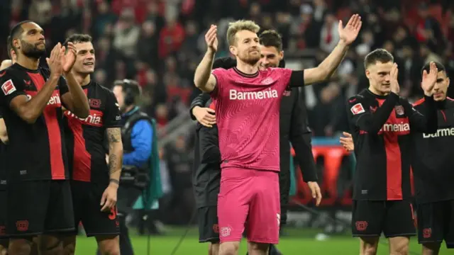 Lukas Hradecky (in pink) celebrates with his Bayer Leverkusen team-mates