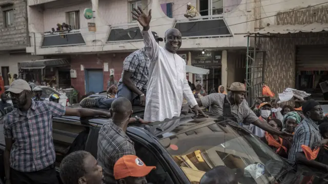 Idrissa Seck, presidential candidate, waves to supporters from a car during a rally in Dakar, Senegal, on Saturday, March 16, 2024.