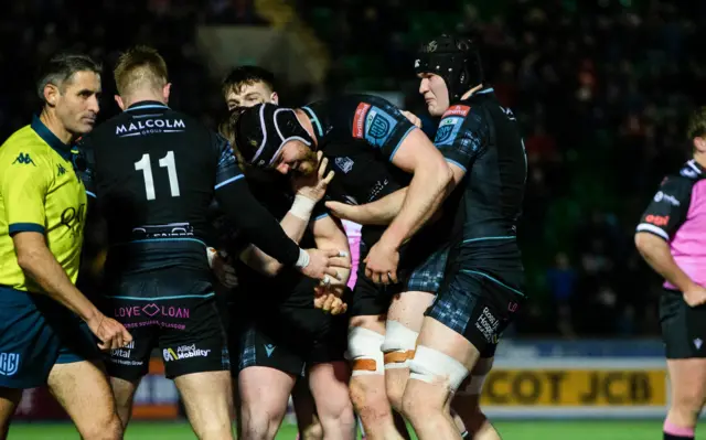 Max Williamson is congratulated by his Glasgow teammates