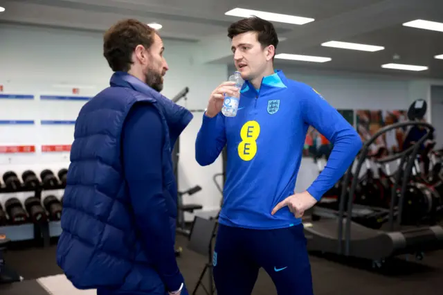 Gareth Southgate and Harry Maguire talk in the gym at St George's Park