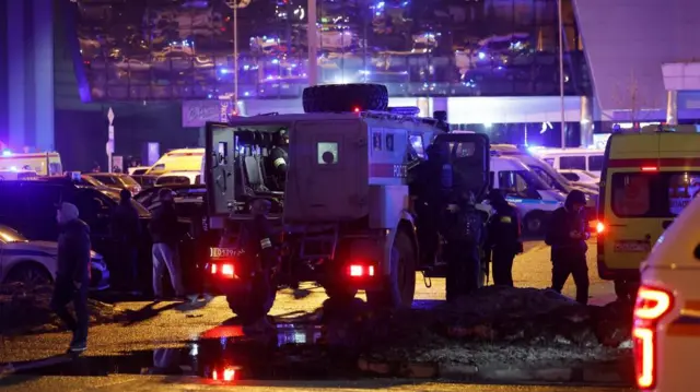 Members of Russian special operations forces are seen near the burning Crocus City Hall concert venue following a shooting incident, outside Moscow, Russia.