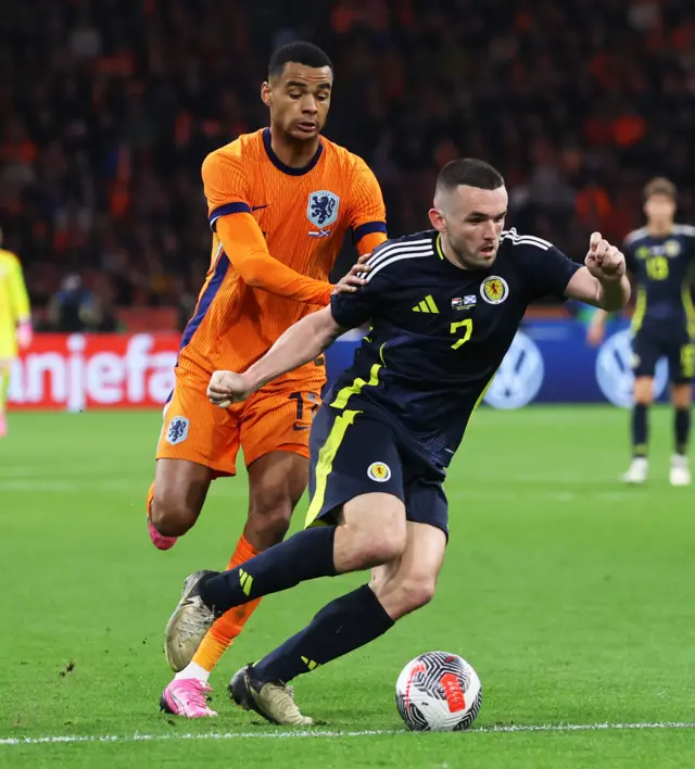 Scotland's John McGinn and Cody Gakpo in action during an international friendly match between the Netherlands and Scotland at the Johan Cruyff Arena