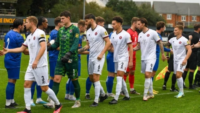 Players shake hands before a game