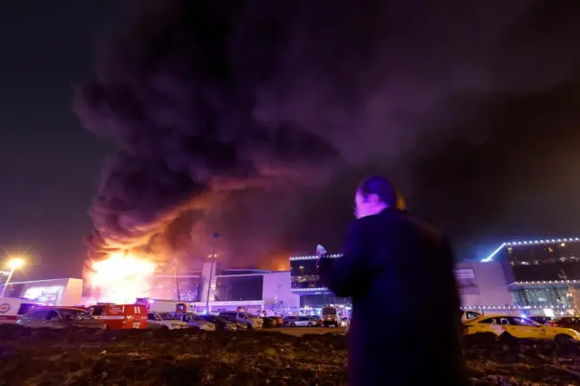 Smoke from fire rises above the burning Crocus City Hall concert venue following a shooting incident, outside Moscow, Russia, March 22, 2024