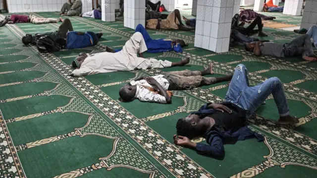 Fasting men sleep in a mosque during the Ramadan in Treichville, a popular district of Abidjan on March 22, 2024.