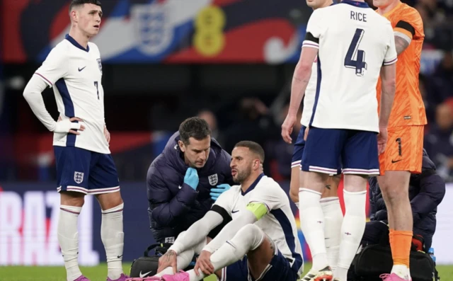 England's Kyle Walker (third left) receives treatment for an injury