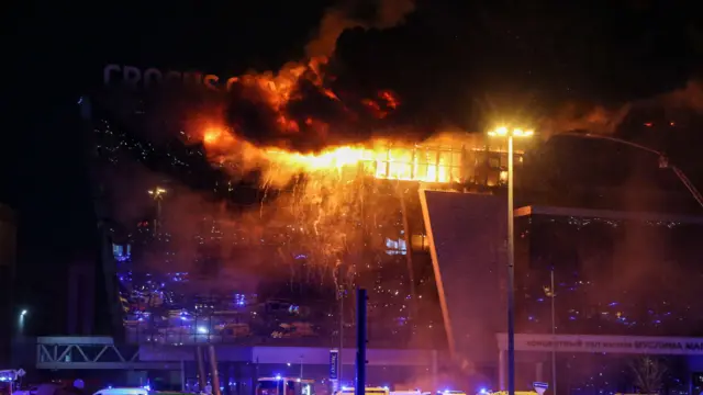 Fire rises above the burning Crocus City Hall concert venue following a shooting in Krasnogorsk, outside Moscow