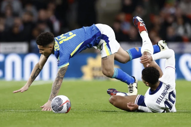 England's Jude Bellingham in action with Brazil's Joao Gomes