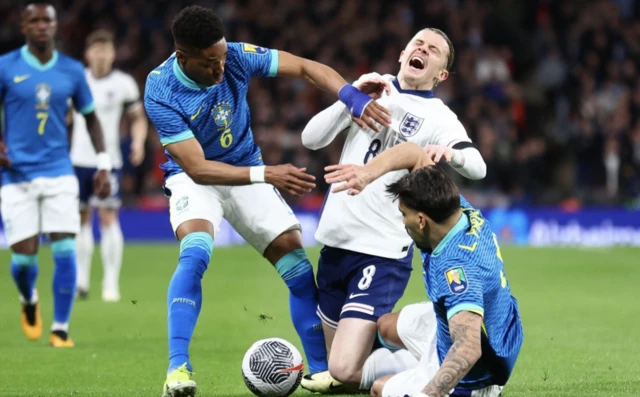 England's Conor Gallagher in action with Brazil's Wendell and Lucas Paqueta