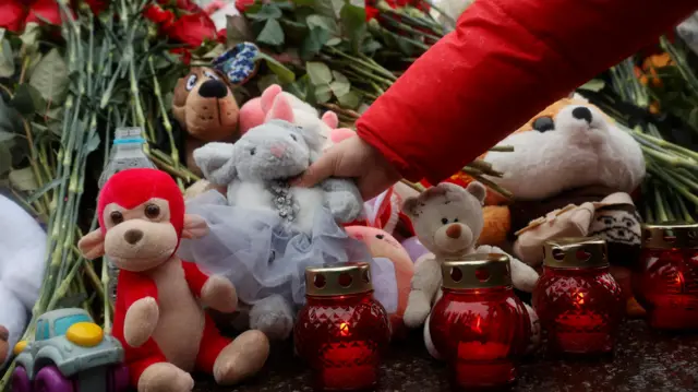 Toys and flowers are placed at a makeshift memorial to the victims of a shooting attack at the Crocus City Hall concert venue in the Moscow Region, Russia