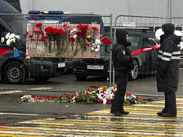 Flowers are laid outside Crocus City Hall in Moscow after a deadly attack that left at least 93 dead