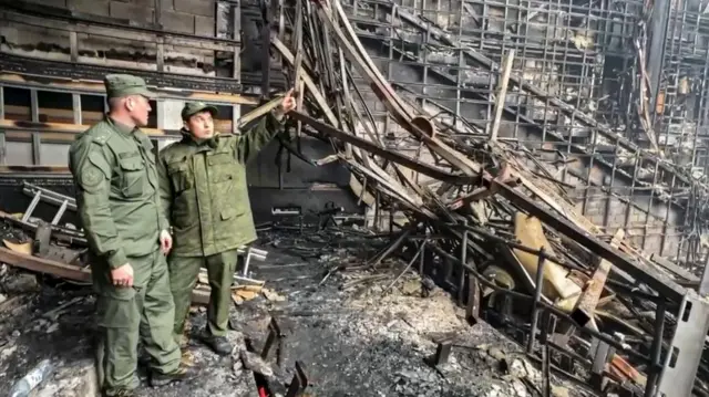 A handout still image taken from handout video provided by the Russian Investigative Committee press-service shows Russian investigators working inside the burned Crocus City Hall concert venue following a terrorist attack in Krasnogorsk, outside Moscow, Russia, 23 March 2024.