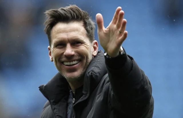 Gareth Taylor smiles and waves