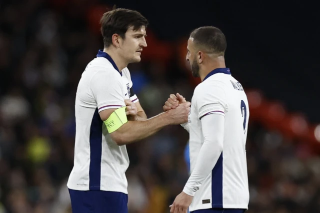 England's Harry Maguire receives the captain's armband as Kyle Walker is substituted off