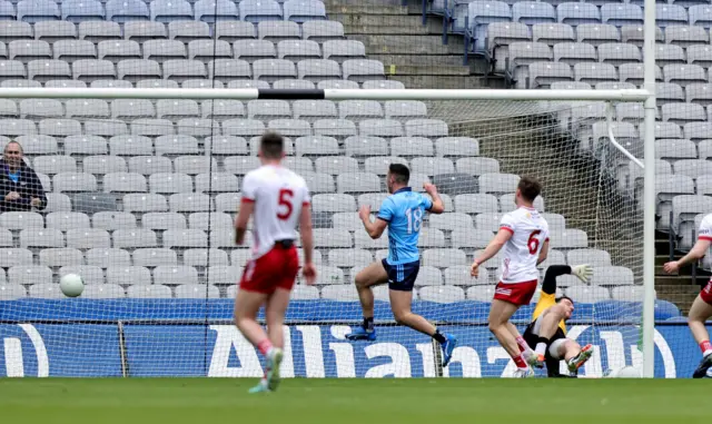 Dublin's Colm Basquel shoots past Niall Morgan of Tyrone to score